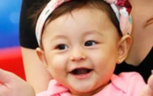 a baby with a pink shirt