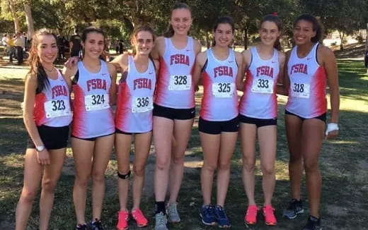 a group of women wearing numbers