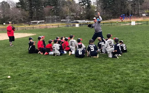 a group of people sitting on the grass