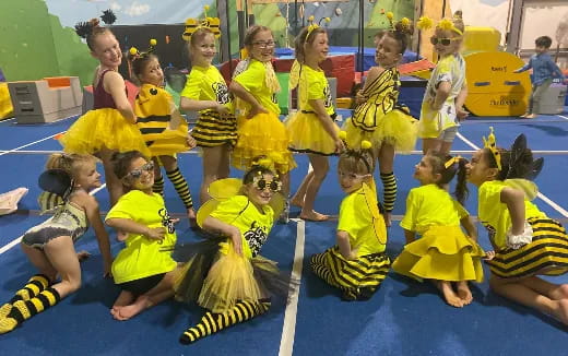 a group of girls in yellow uniforms