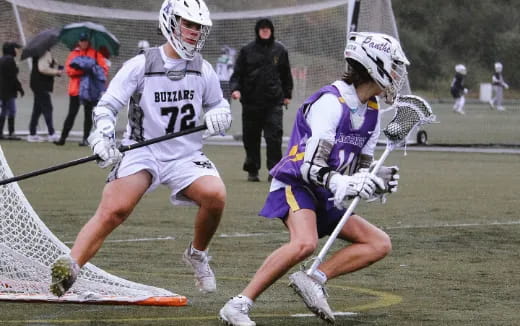 two men playing lacrosse