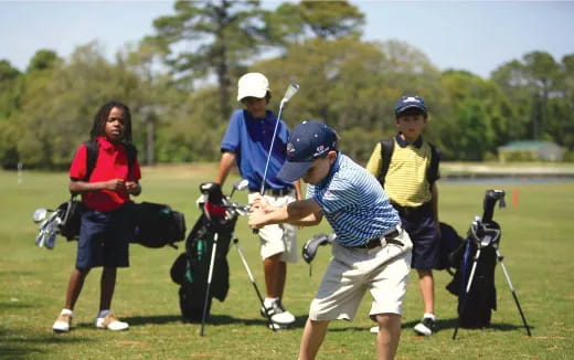 a group of people playing golf