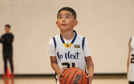 a boy holding a basketball