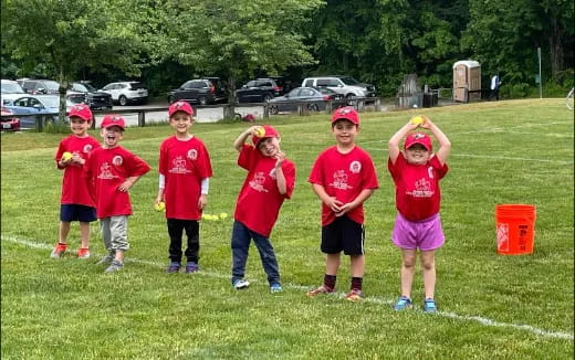 a group of children in red shirts