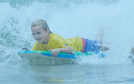 a boy riding a surfboard