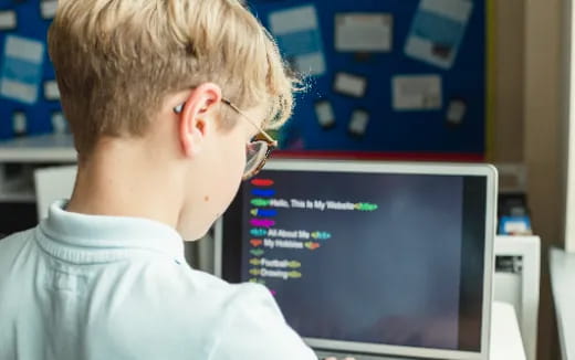 a boy looking at a computer screen