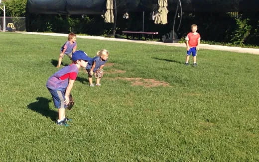 a group of kids playing baseball