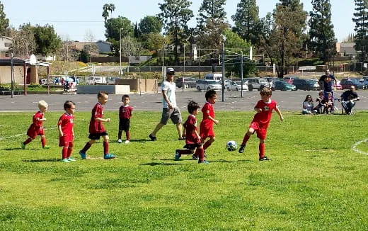 a group of kids playing football