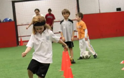 a group of kids playing football