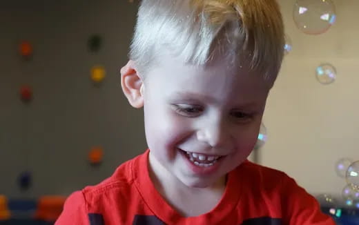 a boy smiling at the camera