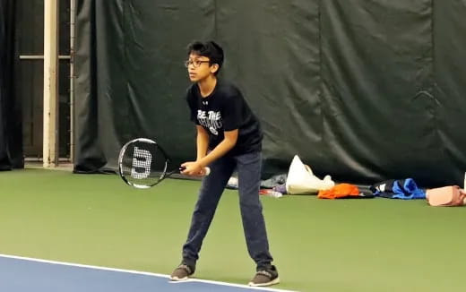 a man holding a tennis racket