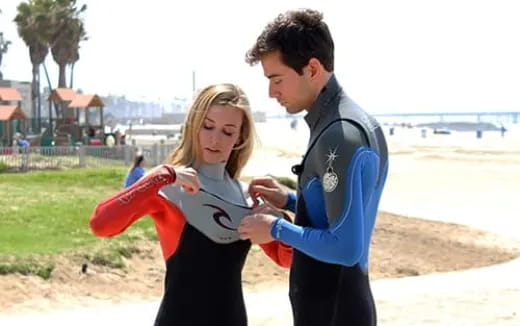 a man and a woman holding a frisbee