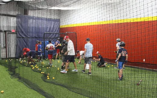 a group of people playing baseball