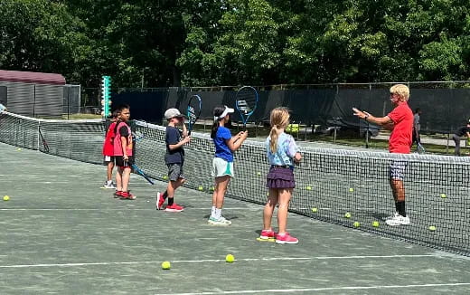 kids playing tennis on a court