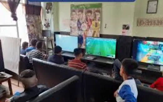 a group of people sitting in a room with computers