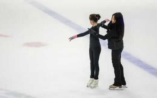 a man and woman ice skating