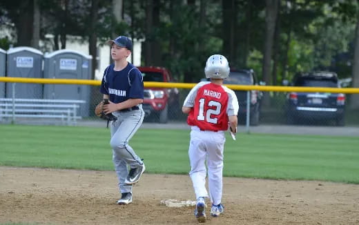 a couple of young boys playing baseball
