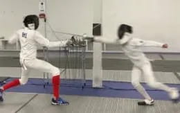 a couple of people in white uniforms in a gym