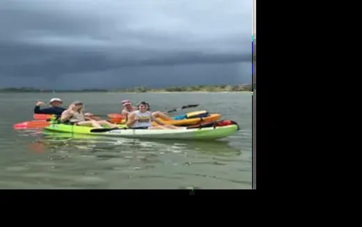a group of people in canoes