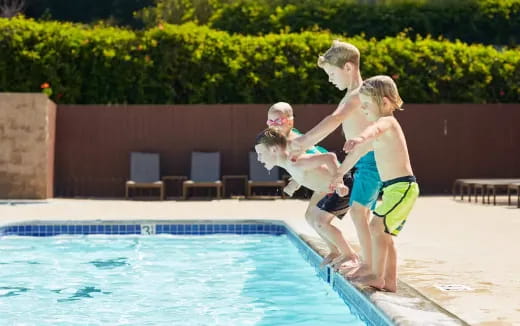 a group of people playing in a swimming pool