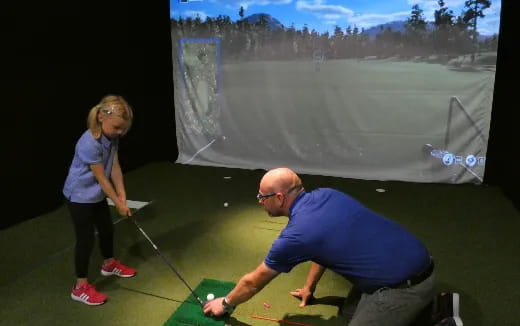 a man and a woman playing golf