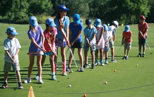 a group of people playing golf