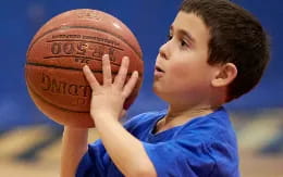 a boy holding a basketball