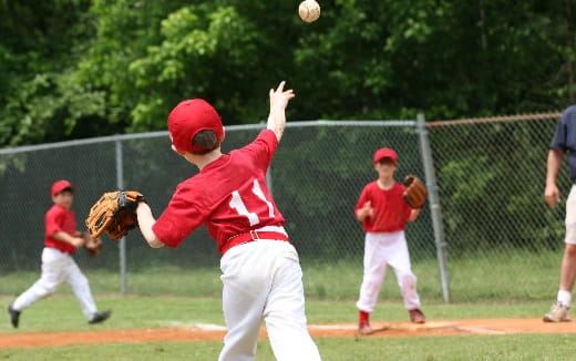 a kid throwing a baseball