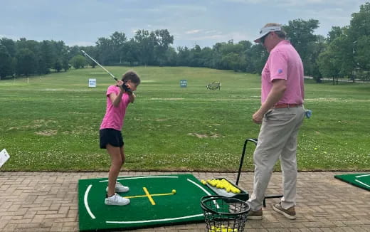 a man and a woman playing golf