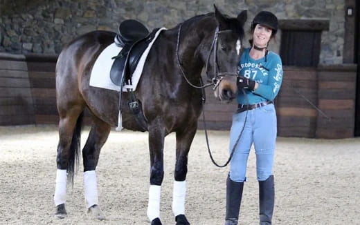 a person standing next to a horse