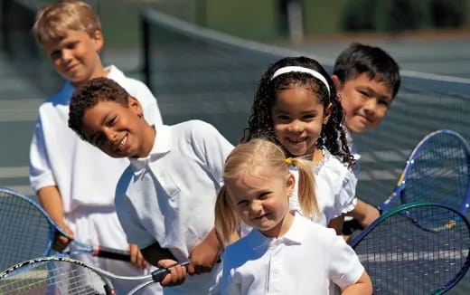a group of people holding tennis rackets