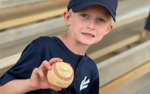 a boy holding a ball