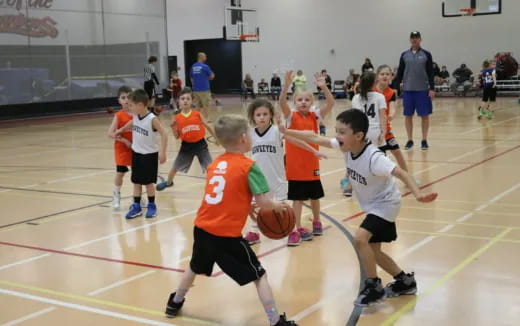 a group of kids playing basketball