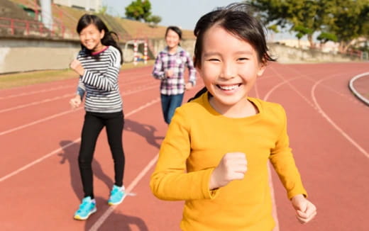 a group of children running on a track