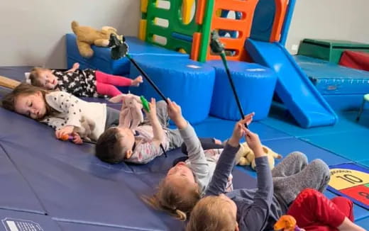 a group of children playing on a mat