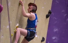 a woman climbing a wall