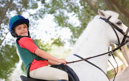 a boy riding a horse