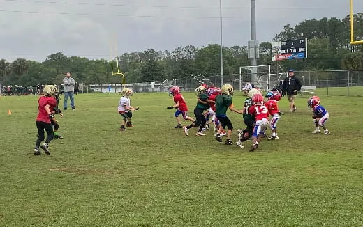 a group of kids playing football