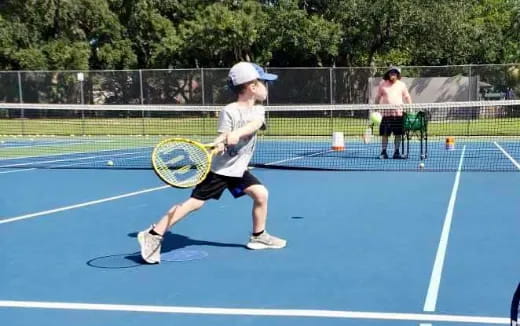 a boy playing tennis