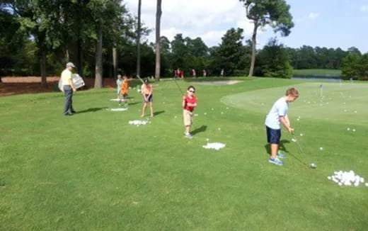 a group of people playing golf