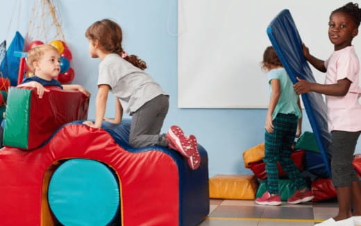 a group of children playing on a colorful slide