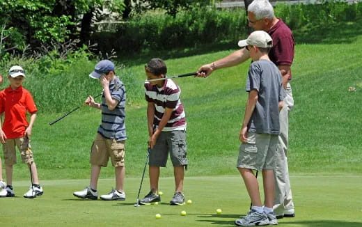 a group of people playing golf