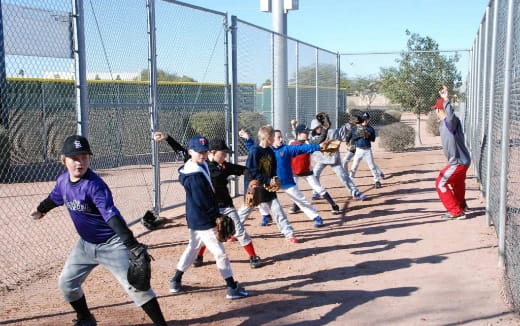 kids playing baseball on a field