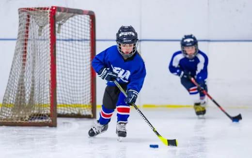 a couple of men playing hockey