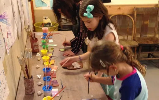 a few young girls painting