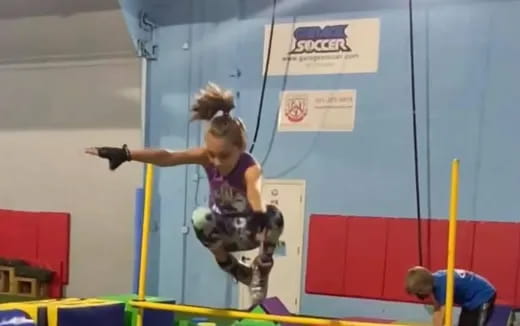 a person jumping over a bar