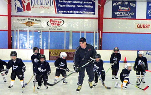 a group of people playing hockey