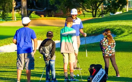 a group of people playing golf