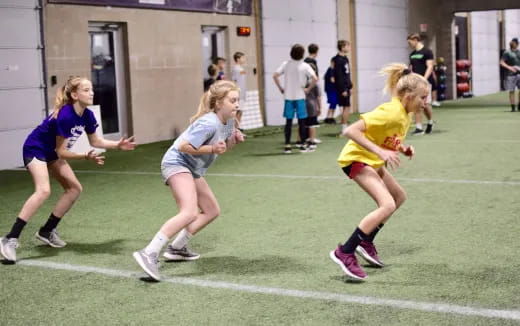a group of girls running on a field