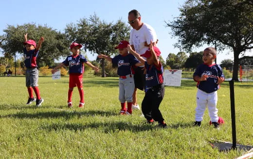 a person and a group of kids playing in a field